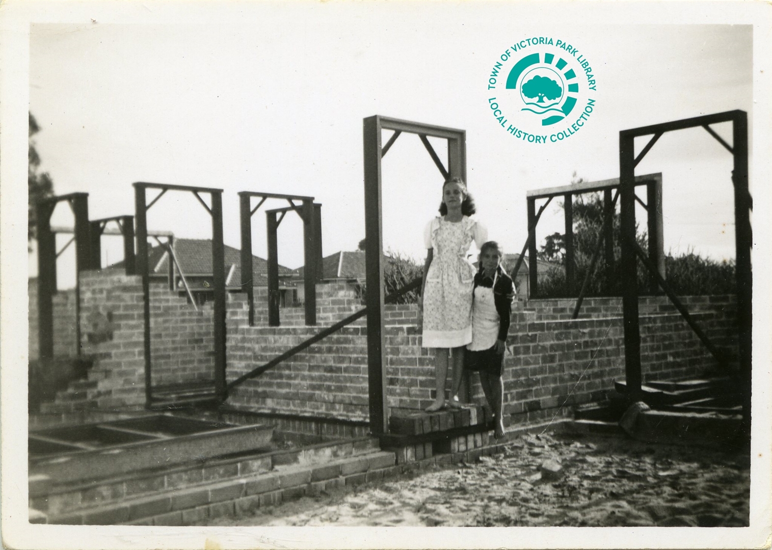 PH00044-06 Bill Holmes’ daughters Doreen Phyllis and Joan Helen Holmes in the brickwork and wooden frames of 28 Star Street, Carlisle, circa 1948 Image