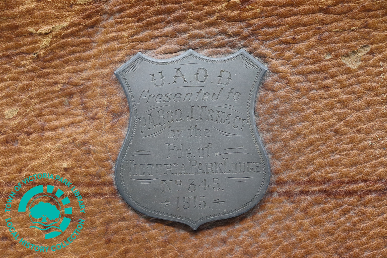 Close-up of engraved dedication on Mr J. Treacy's leather satchel Image