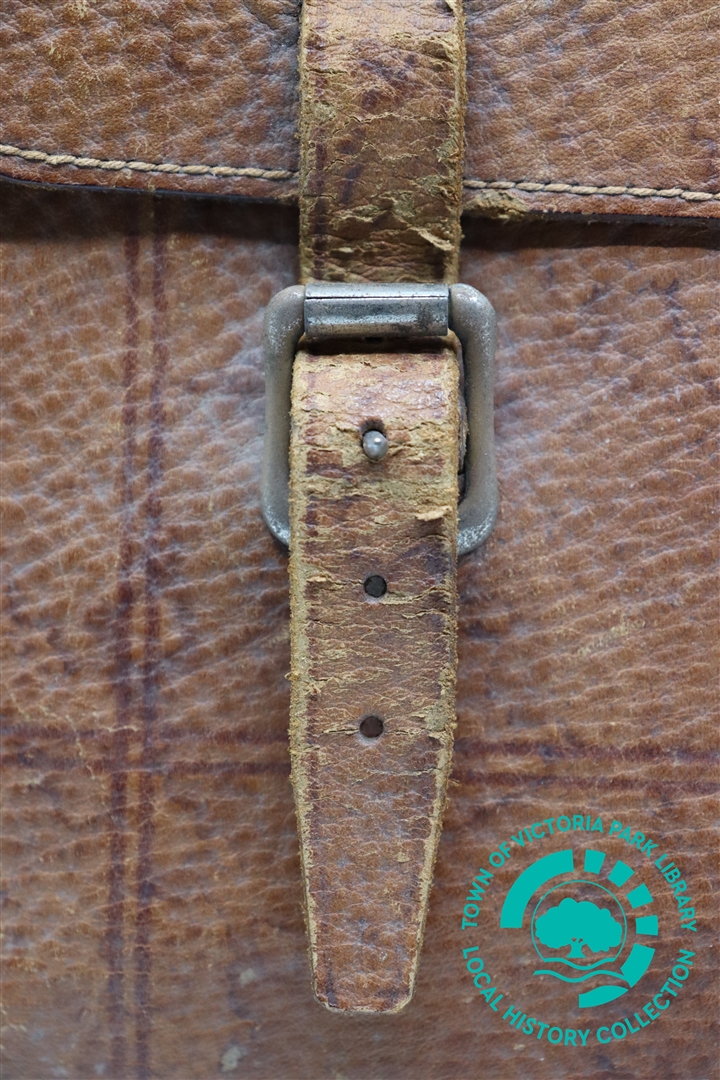 Close-up of buckle on left side of Mr J. Treacy's leather satchel. Image