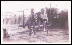 Alec and Janet Bell (later McWhirter) with kittens in the backyard of their family home, circa 1950