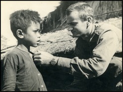  Private Alec Bell checking a young Vietnamese Montagnard boy for fever